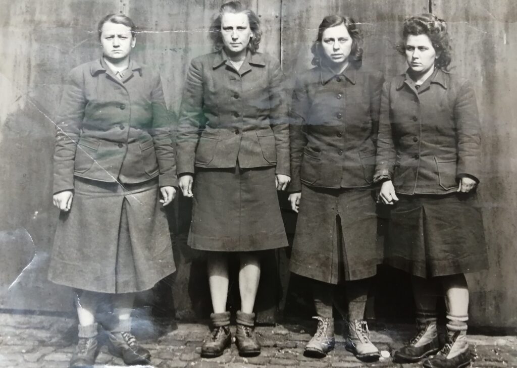 Black and white photgraph of 4 woment on trial at the Belson trials