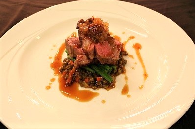 Roast lump of lamb dish on a white plate