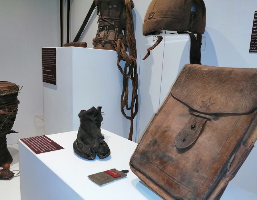 museum exhibition showing artfects that soldiers have brought home from war