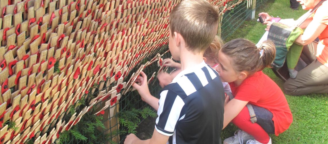 Crosses being laid up at our Memorial Wall on 30th July 2016 in remembrance of the 181 men who were killed at High Wood 100 years before.